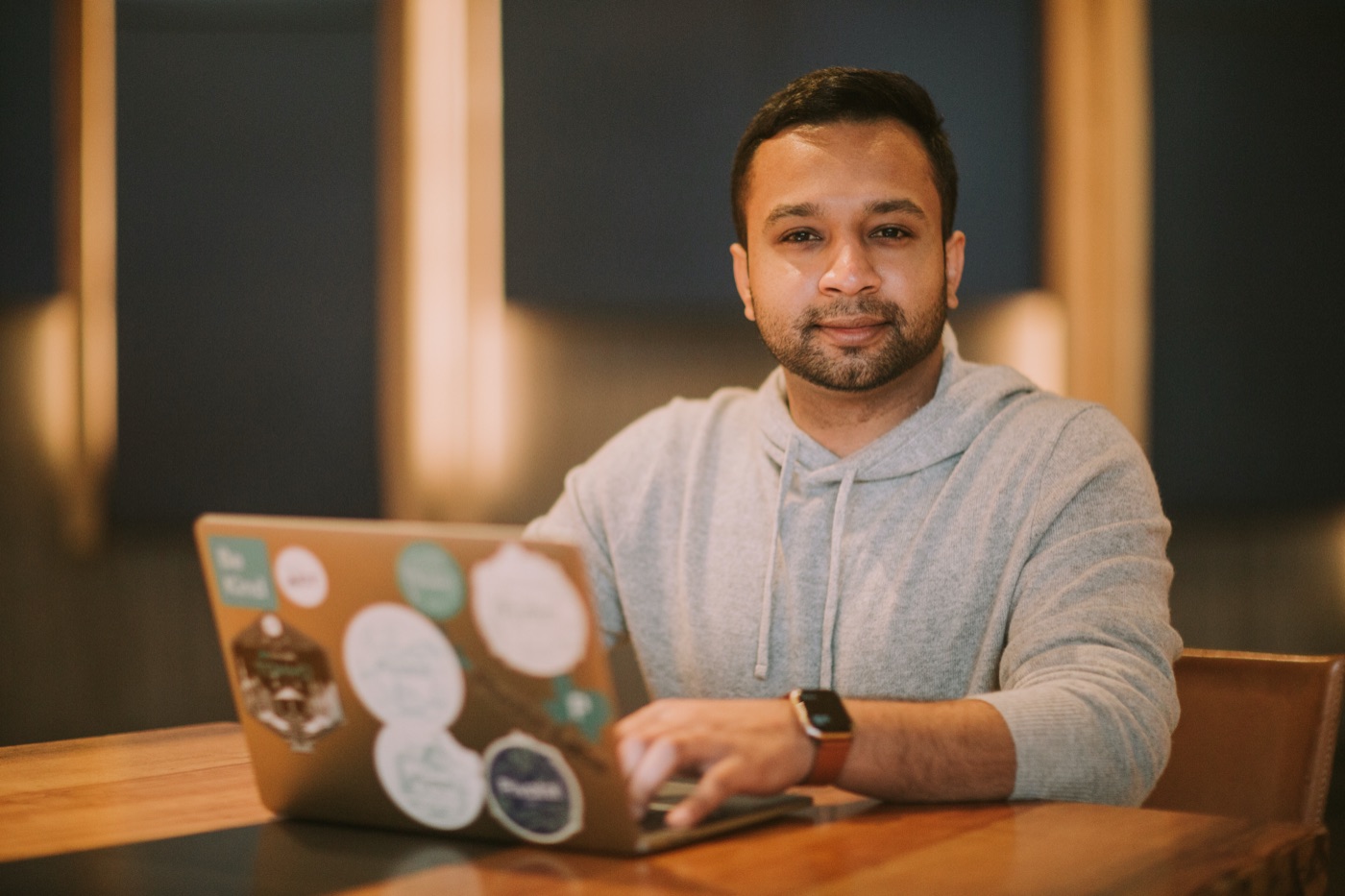 Karthik working at a laptop in a cafe